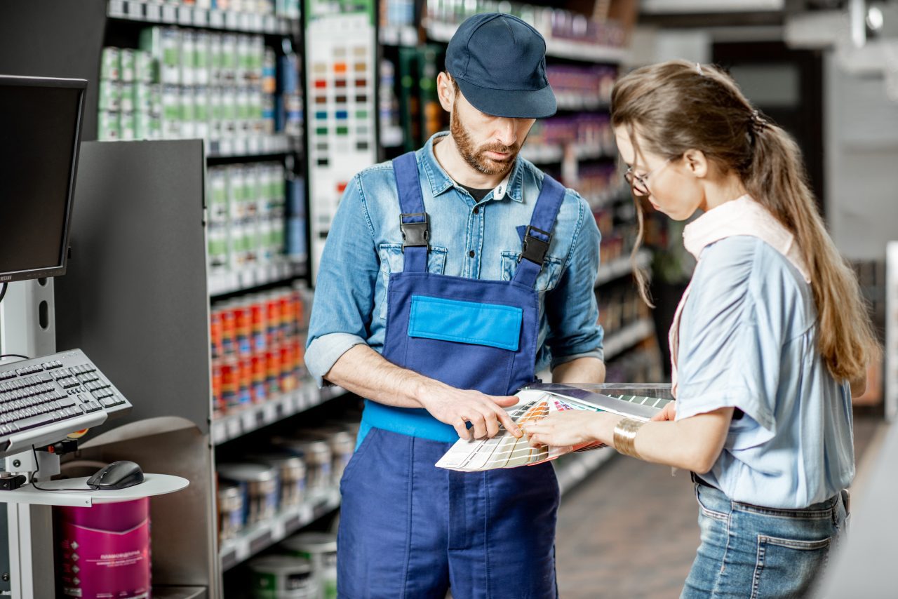 woman choosing paints in the supermarket e1698220811320